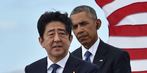 US President Barack Obama (R) listens as Japanese Prime Minister Shinzo Abe speaks at the USS Arizona Memorial on December 27, 2016 at Pearl Harbor in Honolulu, Hawaii.Abe and Obama made a joint pilgrimage to the site of the Pearl Harbor attack on Tuesday to celebrate 'the power of reconciliation. 'The Japanese attack on an unsuspecting US fleet moored at Pearl Harbor turned the Pacific into a cauldron of conflict -- more than 2,400 were killed and a reluctant America was drawn into World War II