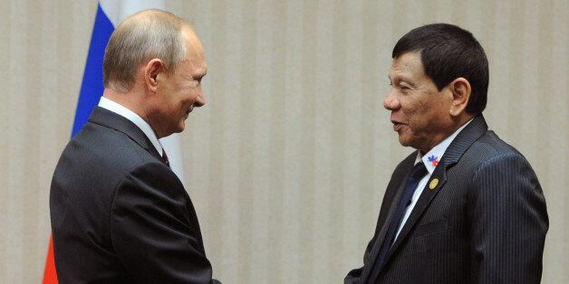 Russian President Vladimir Putin (L) meets with his Philippines' counterpart Rodrigo Duterte on the sidelines of the Asia-Pacific Economic Cooperation Summit (APEC) in Lima on November 19, 2016.  / AFP / SPUTNIK / Mikhail KLIMENTYEV        (Photo credit should read MIKHAIL KLIMENTYEV/AFP/Getty Images)