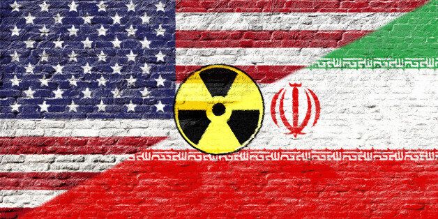 United states and Iran - National flags on Brick wall with nuclear icon