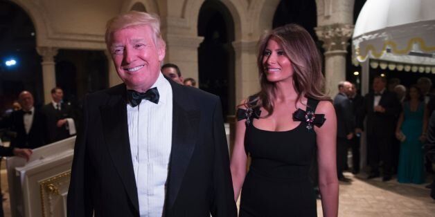 US President-elect Donald Trump arrives with his wife Melania for a New Year's Eve party December 31, 2016 at Mar-a-Lago in Palm Beach, Florida. / AFP / DON EMMERT        (Photo credit should read DON EMMERT/AFP/Getty Images)