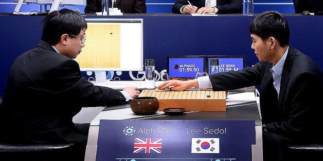 SEOUL, SOUTH KOREA - MARCH 10:  In this handout image provided by Google, South Korean professional Go player Lee Se-Dol (R) puts his first stone against Google's artificial intelligence program, AlphaGo, during the Google DeepMind Challenge Match on March 10, 2016 in Seoul, South Korea. Lee Se-dol is playing a five-match series against a computer program developed by a Google, AlphaGo.  (Photo by Google via Getty Images)