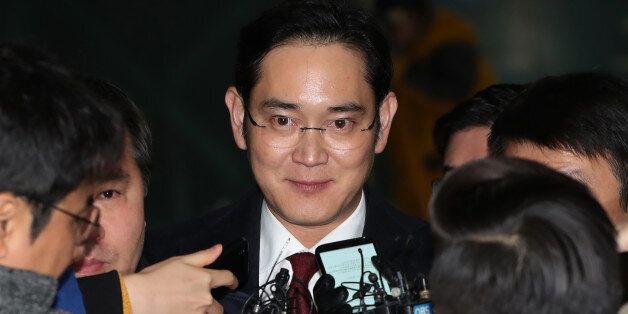 Jay Y. Lee, co-vice chairman of Samsung Electronics Co., center, is surrounded by members of the media as he leaves the special prosecutors' office in Seoul, South Korea, on Friday, Jan. 13, 2017. Special prosecutors began questioning Lee on Thursday as a suspect in a bribery investigation, deepening an influence-peddling scandal that has already led to the impeachment of South Korea's president. Photographer: SeongJoon Cho/Bloomberg via Getty Images
