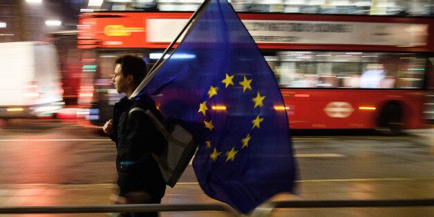 LONDON, ENGLAND - JANUARY 24:  A man carries a European Union flag outside the Supreme Court in Parliament Square ahead of the ruling on whether Parliament have the power to begin the Brexit process, on January 24, 2017 in London, England. The judgement will play an important role in how the Government proceeds with it's planned use of the EU's Article 50 exit clause.  (Photo by Leon Neal/Getty Images)