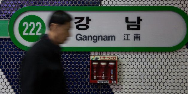 A man walks past signage for Gangnam subway station in Seoul, South Korea, on Thursday, Dec. 13, 2012. South Koreans vote on Dec. 19 to replace President Lee Myung Bak, whose five-year term ends in February. Photographer: SeongJoon Cho/Bloomberg via Getty Images