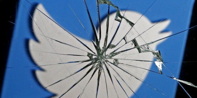 A 3D-printed Twitter logo is seen through broken glass, in this picture illustration taken February 8, 2016. Twitter shed 5.4 percent to hit a new record low of $14.87 after reports over the weekend that the company was planning to change how it display tweets.    REUTERS/Dado Ruvic/Illustration