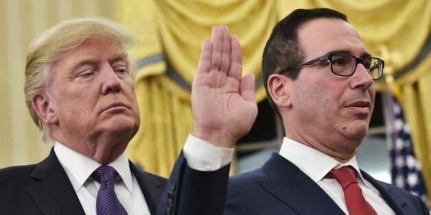 US President Donald Trump (L) watches as US Vice President (out of frame) administers the oath of office to Treasury Secretary Steven Mnuchin (R) in the Oval Office of the White House on February 13, 2017 in Washington, DC. / AFP / MANDEL NGAN        (Photo credit should read MANDEL NGAN/AFP/Getty Images)