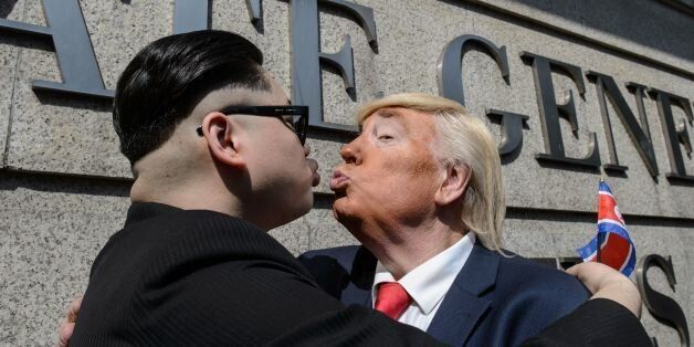North Korean leader Kim Jong-un, impersonated by Hong Kong actor Howard (L), and US President Donald Trump, impersonated by US actor Dennis, pose outside the US consulate in Hong Kong on January 25, 2017.US President Donald Trump and North Korean leader Kim Jong-un might never be best buddies, but convincing impersonators are giving Hong Kongers a glimpse of what their improbable friendship might look like. Describing themselves as political satirists, the pair hugged and pretended to kiss as th