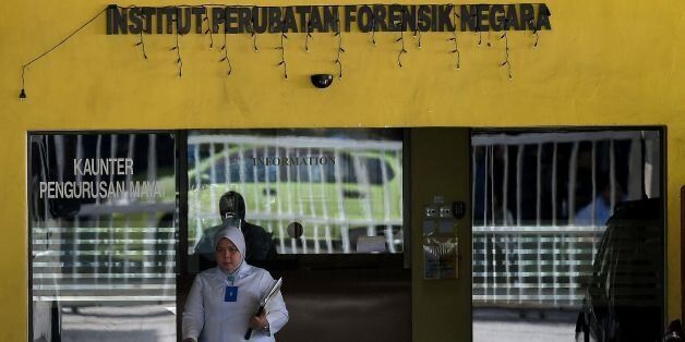 A Malaysian forensic official walks out of the Forensic wing at the Hospital Kuala Lumpur on February 16, 2017, where the body of a North Korean man suspected to be Kim Jong-Nam, half-brother of a North Korean leader Kim Jong-Un, is being kept.Malaysia will return the body of the half-brother of North Korea's leader, the country's deputy prime minister said on February 16, as police probing the airport assassination arrested a second woman. / AFP / Manan VATSYAYANA        (Photo credit should re