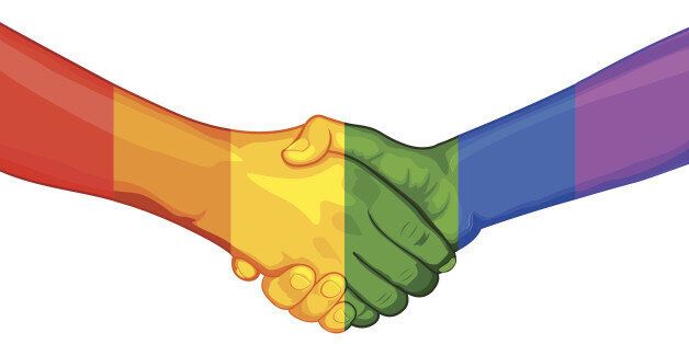 illustration of handshake with painted hand in rainbow flag LGBT color