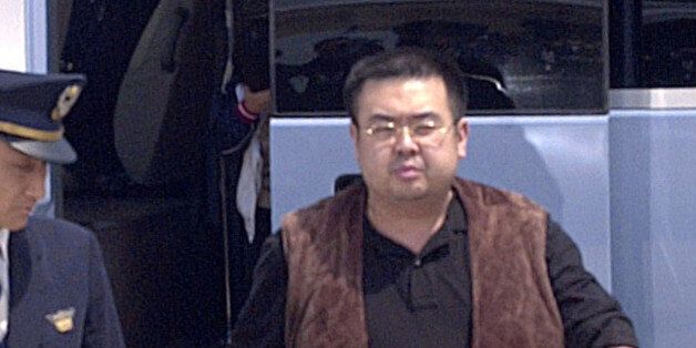A man (R) believed to be North Korean heir-apparent Kim Jong Nam, is escorted by police as he boards a plane upon his deportation from Japan at Tokyo's Narita international airport in Narita, Japan, in this photo taken by Kyodo May 4, 2001. Picture taken May 4, 2001. Mandatory credit Kyodo/via REUTERS ATTENTION EDITORS - THIS IMAGE WAS PROVIDED BY A THIRD PARTY. EDITORIAL USE ONLY. MANDATORY CREDIT. JAPAN OUT. NO COMMERCIAL OR EDITORIAL SALES IN JAPAN.