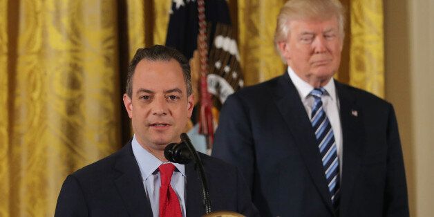 U.S. President Donald Trump stands behinds Chief of Staff Reince Priebus after a swearing-in ceremony for senior staff at the White House in Washington, DC January 22, 2017. REUTERS/Carlos Barria