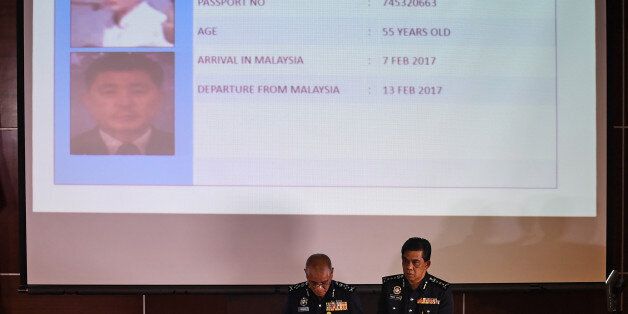 Royal Malaysian Police deputy inspector-general Noor Rashid Ibrahim (centre L) speaks about North Korean suspect O Jong Gil (top) during a press conference as Selangor state police chief Abdul Samah Mat (centre R) looks on, at the Bukit Aman national police headquarters in Kuala Lumpur on February 19, 2017, following the February 13 assassination of Kim Jong-Nam, the half brother of North Korean leader Kim Jong-Un.Malaysian police said on February 19 they were seeking four more North Korean susp