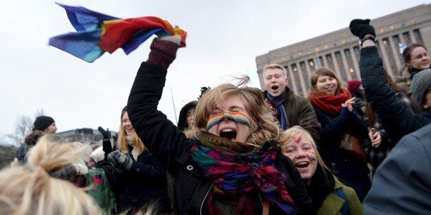 Supporters of the same-sex marriage celebrate outside the Finnish Parliament in Helsinki, Finland on November 28, 2014 after the Finnish parliament approved a bill allowing homosexual marriage. AFP PHOTO /Lehtikuva/ MIKKO STIG*** FINLAND OUT ***        (Photo credit should read MIKKO STIG/AFP/Getty Images)