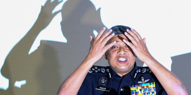 Malaysia's Royal Police Chief Khalid Abu Bakar demonstrates to the media during a news conference regarding the apparent assassination of Kim Jong Nam, the half-brother of the North Korean leader, at the Malaysian police headquarters in Kuala Lumpur, Malaysia, February 22, 2017. REUTERS/Athit Perawongmetha