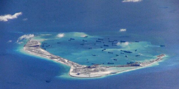 FILE PHOTO: Chinese dredging vessels are purportedly seen in the waters around Mischief Reef in the disputed Spratly Islands in the South China Sea in this still image from video taken by a P-8A Poseidon surveillance aircraft provided by the United States Navy May 21, 2015.  U.S. Navy/Handout via Reuters/File Photo   ATTENTION EDITORS - THIS IMAGE WAS PROVIDED BY A THIRD PARTY. EDITORIAL USE ONLY. THIS PICTURE WAS PROCESSED BY REUTERS TO ENHANCE QUALITY. AN UNPROCESSED VERSION IS AVAILABLE IN OU