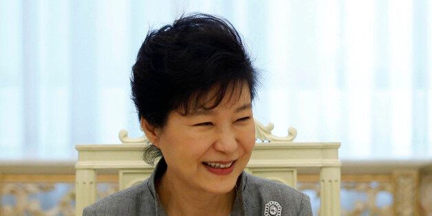 South Korean President Park Geun-hye smiles as she listen to a reporter's question during an interview with Reuters at the Presidential Blue House in Seoul September 16, 2014. Park, thwarted so far in ambitious plans to begin the process of reunifying the Korean peninsula, said the door is open for talks with the North during the upcoming U.N. General Assembly. However, Park said in the interview that Pyongyang must show sincerity in seeking a constructive dialog and