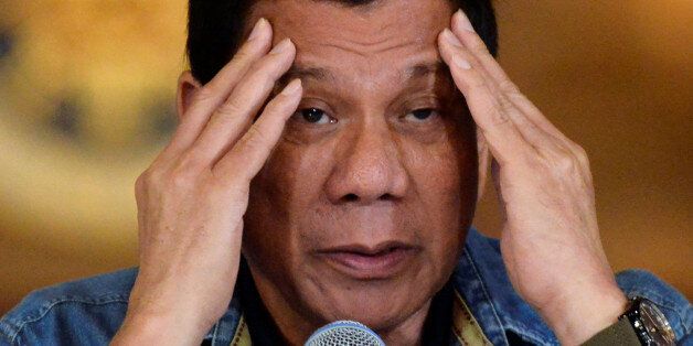 Philippine President Rodrigo Duterte gestures while speaking during a late night news conference at the presidential palace in Manila, Philippines January 29, 2017. REUTERS/Ezra Acayan