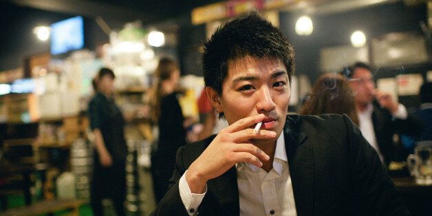 Young man smoking in Roppongi, Japan.
