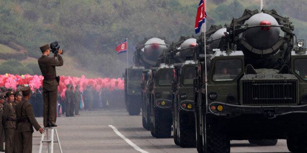 A North Korean soldier films military vehicles carrying missiles during a parade to commemorate the 65th anniversary of founding of the Workers' Party of Korea in Pyongyang October 10, 2010. REUTERS/Petar Kujundzic  (NORTH KOREA - Tags: MILITARY POLITICS ANNIVERSARY)