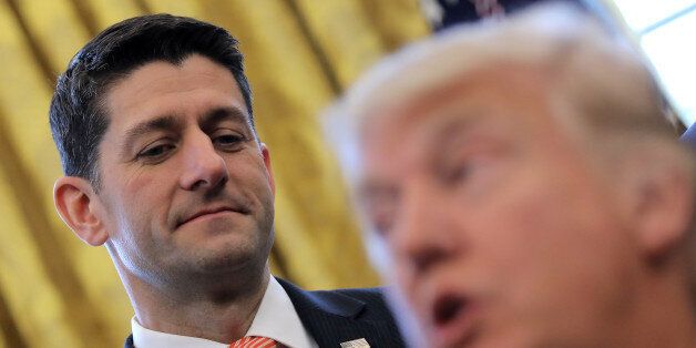 U.S. Speaker of the House Paul Ryan looks at U.S. President Donald Trump as he signs H.J.Res. 41, providing for congressional disapproval of a rule submitted by the Securities and Exchange Commission relating to