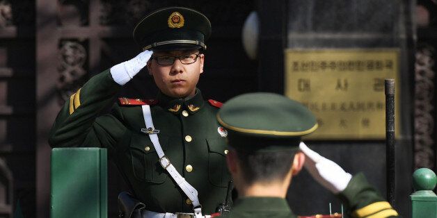 Chinese paramilitary police officers salute each other at the entrance of the North Korean embassy in Beijing on March 7, 2017. North Korea's ambassador to Malaysia Kang Chol is believed to be in the Bejing embassy after he was expelled from Malaysia in a deepening diplomatic dispute over the assassination of the half brother of Pyongyang's leader. / AFP PHOTO / GREG BAKER        (Photo credit should read GREG BAKER/AFP/Getty Images)