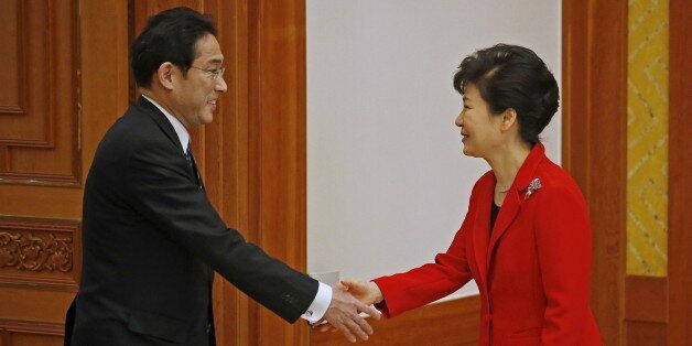 South Korea President Park Geun-hye (R) shakes hands with  Japanese Foreign Minister Fumio Kishida during their meeting at the Presidential Blue House in Seoul March 21, 2015. The foreign ministers of South Korea, Japan and China on Saturday hold their first meeting in three years, in a bid to warm frosty ties and restore a regular three-way summit of their leaders, stalled because of tensions over history and territory.  REUTERS/Kim Hong-Ji