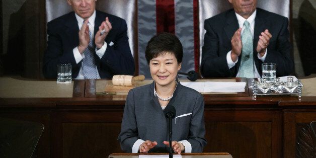 FILE PHOTO: South Korea's President Park Geun-hye is applauded by U.S. Vice President Joe Biden (L) and House Speaker John Boehner (R-OH) as she addresses a joint meeting of Congress in Washington May 8, 2013.  REUTERS/Gary Cameron/File Photo