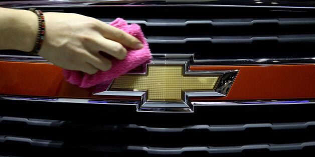 An event staff member wipes a General Motors Corp. (GM) Chevrolet Trax vehicle during the press day of the 2014 Busan International Motor Show in Busan, South Korea, on Thursday, May 29, 2014. The Motor Show runs until June 8. Photographer: SeongJoon Cho/Bloomberg via Getty Images