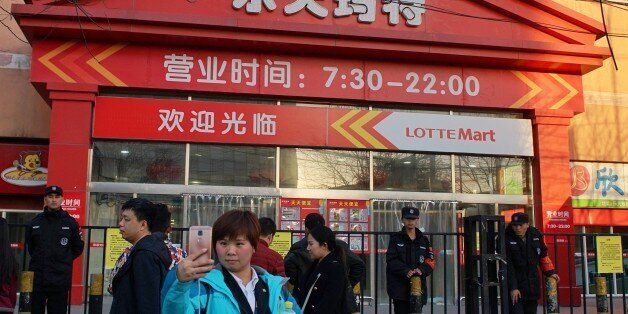 BEIJING, CHINA - MARCH 13: Citizens walk past a supermarket of South Korea's Lotte Group, which is shut down for violating fire safety rules on March 13, 2017 in Beijing, China. Lotte has faced growing opposition in China since signing a deal to provide land to host the Terminal High-Altitude Area Defense (THAAD) system. And dozens of Lotte stores have been closed in China. (Photo by VCG/VCG via Getty Images)