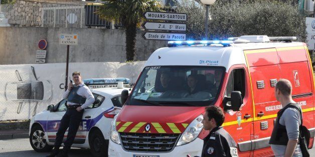 Policemen stand near a police and a firefighter vehicle in the southern French town of Grasse, on March 16, 2017 following a shooting in the Tocqueville high school that left two people injured.At least two people were injured in a shooting at a high school in the southern French town of Grasse on March 16, 2017 which saw the head teacher targeted, police and local authorities said. One 17-year-old pupil armed with a rifle, two handguns and two grenades was arrested after the shooting at the Tocqueville high school, a police source told AFP, asking not to be named. / AFP PHOTO / Valery HACHE        (Photo credit should read VALERY HACHE/AFP/Getty Images)