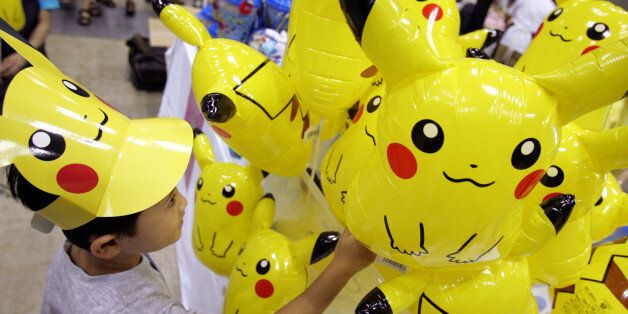 A Japanese boy chooses a Pokemon balloon during Pokemon Festa 2005 in Yokohama, south of Tokyo August 20, 2005. Over 900,000 people attended the largest Pokemon event in Japan in nine places during this summer. REUTERS/Toru Hanai  TH/KI