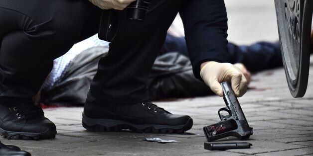 EDITORS NOTE: Graphic content / An Ukrainian police expert seizes a gun at the scene where former Russian MP Denis Voronenkov was shot dead on March 23, 2017 in the center of Kiev.Ukrainian President blamed Russia for the murder of Voronenkov, who moved to Ukraine last year and was wanted by Russia for fraud, saying it was an 'act of state terrorism.'  / AFP PHOTO / Sergei SUPINSKY        (Photo credit should read SERGEI SUPINSKY/AFP/Getty Images)