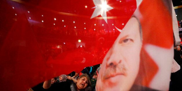 People wave with flags showing Turkish President Recep Tayyip Erdogan before Turkish Prime Minister Binali Yildirim is expected to address a crowd of around 10,000 in Oberhausen, Germany, February 18, 2017, to promote Turkey's constitution referendum on April 16, 2017.      REUTERS/Wolfgang Rattay     TPX IMAGES OF THE DAY