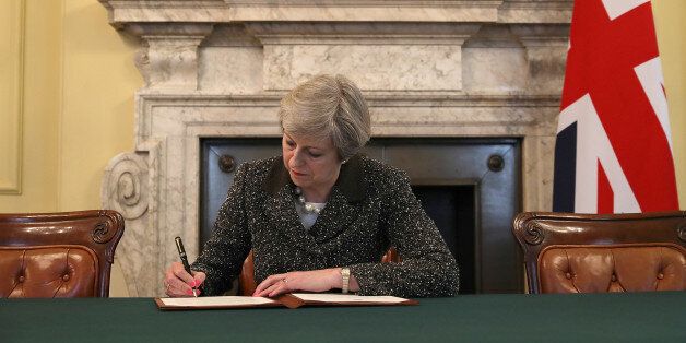 British Prime Minister Theresa May in the cabinet office signs the official letter to European Council President Donald Tusk invoking Article 50 and the United Kingdom's intention to leave the EU on March 28, 2017 in London, England. After holding a referendum in June 2016 the United Kingdom voted to leave the European Union, the signing of Article 50 now officially triggers that process. REUTERS/Christopher Furlong/Pool     TPX IMAGES OF THE DAY