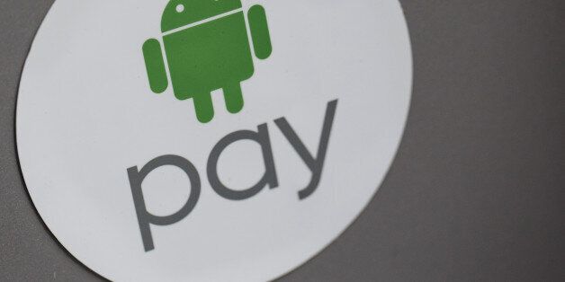 Signage for Google Inc.'s Android Pay is displayed outside a store in Hong Kong, China, on Tuesday, Nov. 1, 2016. The urgency to prepare regulatory environments for fintech is growing as banks begin offering digital services such as biometric authentication and as mobile-payment systems such as Apple Pay and AliPay are introduced around the region. Photographer: Anthony Kwan/Bloomberg via Getty Images