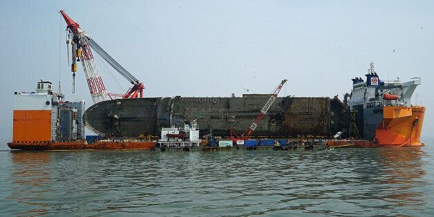 JINDO-GUN, SOUTH KOREA - MARCH 28:  In this handout photo released by the South Korean Ministry of Oceans and Fisheries, The sunken ferry Sewol is seen on a semi-submersible transport vessel during the salvage operation in waters off Jindo, on March 28, 2017 in Jindo-gun, South Korea. The Sewol sank off the Jindo Island in April 2014 leaving more than 300 people dead and nine of them still remain missing. Workers are in the process of an attempt to raise the ferry from the water in the hope that