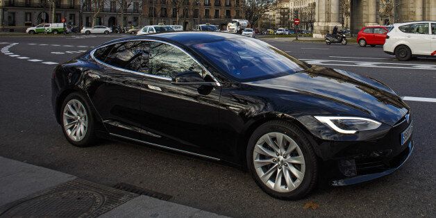 A Tesla Motors Inc. Model S electric automobile, operated Uber Technologies Inc., drives past the Puerta de Alcala in Plaza de la Independencia in Madrid, Spain, on Friday, Jan. 13, 2017. Ride-hailing service Uber Technologies has launched its first electric car taxi service in Madrid, operating a fleet of Tesla Model S electric vehicles. Photographer: Angel Navarrete/Bloomberg via Getty Images