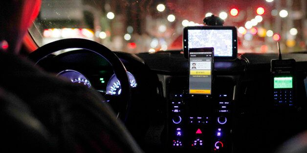 A smartphone showing the Kakao Taxi app, developed by Daum Kako Corp., sits mounted on the dashboard of a taxi in Seoul, South Korea, on Friday, July 17, 2015. A report on July 23 may show that South Korea's economy expanded 2.3 percent in the second quarter, which would be the slowest pace in more than two years, according to the median estimate in a Bloomberg survey. Photographer: Woohae Cho/Bloomberg via Getty Images