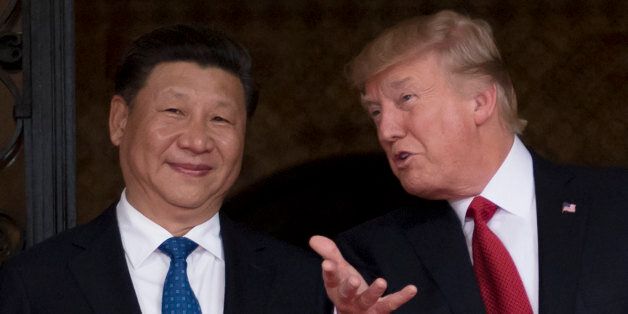 US President Donald Trump (R) welcomes Chinese President Xi Jinping (L) to the Mar-a-Lago estate in West Palm Beach, Florida, on April 6, 2017. / AFP PHOTO / JIM WATSON        (Photo credit should read JIM WATSON/AFP/Getty Images)