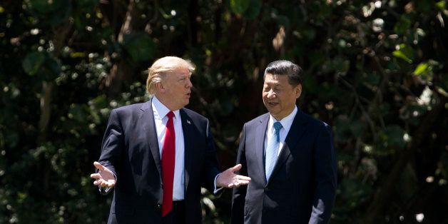US President Donald Trump (L) and Chinese President Xi Jinping (R) walk together at the Mar-a-Lago estate in West Palm Beach, Florida, April 7, 2017.President Donald Trump entered a second day of talks with his Chinese counterpart Xi Jinping on Friday hoping to strike deals on trade and jobs after an overnight show of strength in Syria. / AFP PHOTO / JIM WATSON        (Photo credit should read JIM WATSON/AFP/Getty Images)