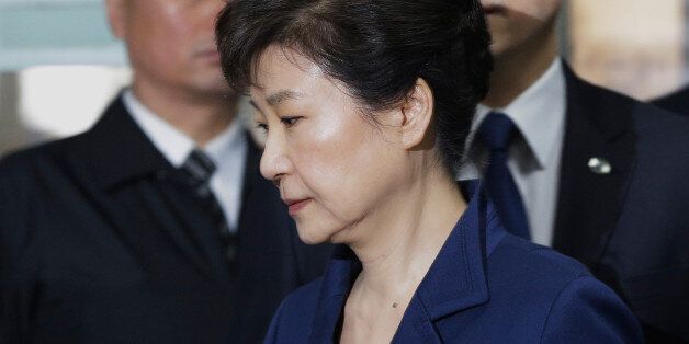 South Korea's ousted president Park Geun-Hye (front) arrives for questioning on her arrest warrant at the Seoul Central District Court in Seoul on March 30, 2017.Park arrived at court on March 30 for a hearing to decide whether she should be arrested over the corruption and abuse of power scandal that brought her down. / AFP PHOTO / POOL / Ahn Young-joon        (Photo credit should read AHN YOUNG-JOON/AFP/Getty Images)