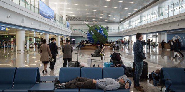 Travellers wait at Pyongyang airport on April 17, 2017.Tourists and foreign journalists, who attended the huge military parade on April 15 during which North Korea showcased apparent intercontinental ballistic missiles, were left waiting at Pyongyang airport as flights were delayed. / AFP PHOTO / ED JONES        (Photo credit should read ED JONES/AFP/Getty Images)