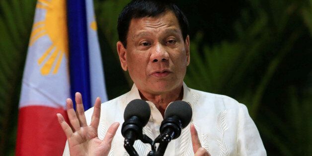 Philippine President Rodrigo Duterte gestures while answering questions during a news conference upon arrival from a trip to Myanmar and Thailand at an international airport in Manila, Philippines March 23, 2017. REUTERS/Romeo Ranoco