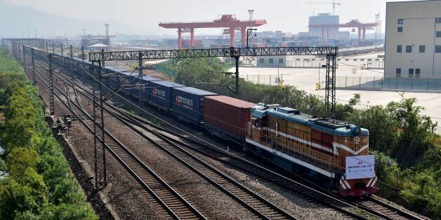 A freight train transporting containers laden with goods from London, arrives at Yiwu railway port station in Yiwu, east China's Zhejiang province on April 29, 2017. Laden with whisky and baby milk, the first freight train linking China directly to the UK arrived in the eastern Chinese city of Yiwu on April 29 after a 12,000-kilometre (7,500-mile) trip, becoming the world's second-longest rail route. / AFP PHOTO / STR / China OUT        (Photo credit should read STR/AFP/Getty Images)