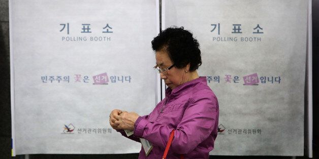 SEOUL, SOUTH KOREA - MAY 04:  A South Korean woman leaves after casting her preliminary vote in a polling station on May 4, 2017 in Seoul, South Korea. Preliminary voting has started at local polling stations across South Korea prior to the primary Presidential election on May 9,  2017.  (Photo by Chung Sung-Jun/Getty Images)