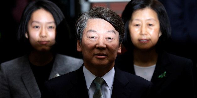 Ahn Cheol-soo, the presidential candidate of the People's Party, his wife Kim Mi-kyung and daughter Ahn Seol-hee (L) speak to the media after voting at a polling station in Seoul, South Korea, May 9, 2017. REUTERS/Kim Hong-Ji