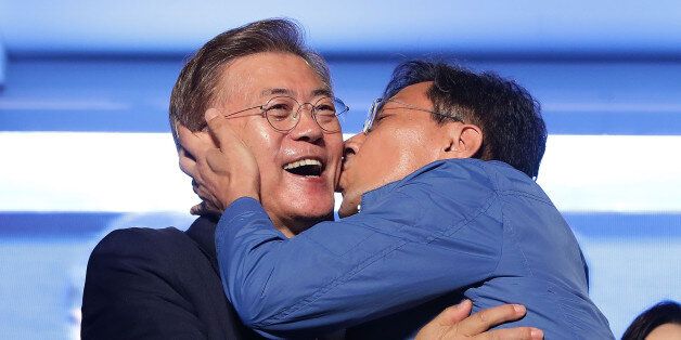SEOUL, SOUTH KOREA - MAY 09:  South Chungcheong governor An Hee-jung kisses South Korean President-elect Moon Jae-in, of the Democratic Party of Korea, at Gwanghwamun Square on May 9, 2017 in Seoul, South Korea. Moon Jae-in declared victory in South Korea's presidential election, which was called seven months early after former President Park Geun-hye was impeached for her involvement in a corruption scandal.  (Photo by Chung Sung-Jun/Getty Images)