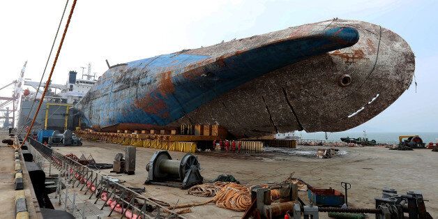 MOKPO, SOUTH KOREA - APRIL 1: In this handout photo released by the South Korean Ministry of Oceans and Fisheries, The sunken ferry Sewol sitting on a semi-submersible transport vessel arrived at a port in Mokpo on April 1, 2017 in Mokpo, South Korea. The Sewol sank off the Jindo Island in April 2014 leaving more than 300 people dead and nine of them still remain missing. (Photo by South Korean Ministry of Oceans and Fisheries via Getty Images)