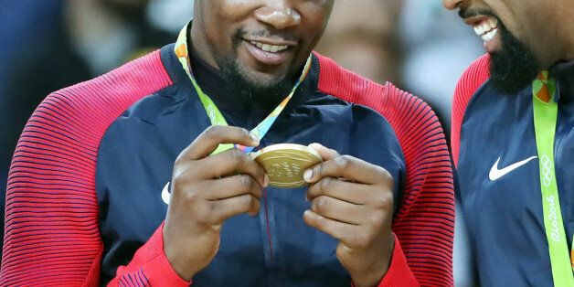 RIO DE JANEIRO, Aug. 21, 2016-- Kevin Durant and DeAndre Jordan, right, of the United States of America attend the awarding ceremony for the men's final of Basketball at the 2016 Rio Olympic Games in Rio de Janeiro, Brazil, on Aug. 21, 2016. The United States of America won the gold medal. (Xinhua/Meng Yongmin via Getty Images)