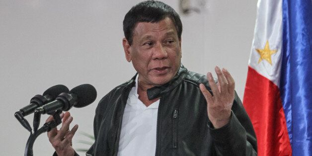 Philippine President Rodrigo Duterte gestures as he speaks shortly after arriving in Davao on May 16, 2017, from a working visit to China.Duterte said on May 16 he was open to jointly exploration with Beijing resources in the disputed South China Sea, following a meeting with Chinese President Xi Jinping. / AFP PHOTO / MANMAN DEJETO        (Photo credit should read MANMAN DEJETO/AFP/Getty Images)